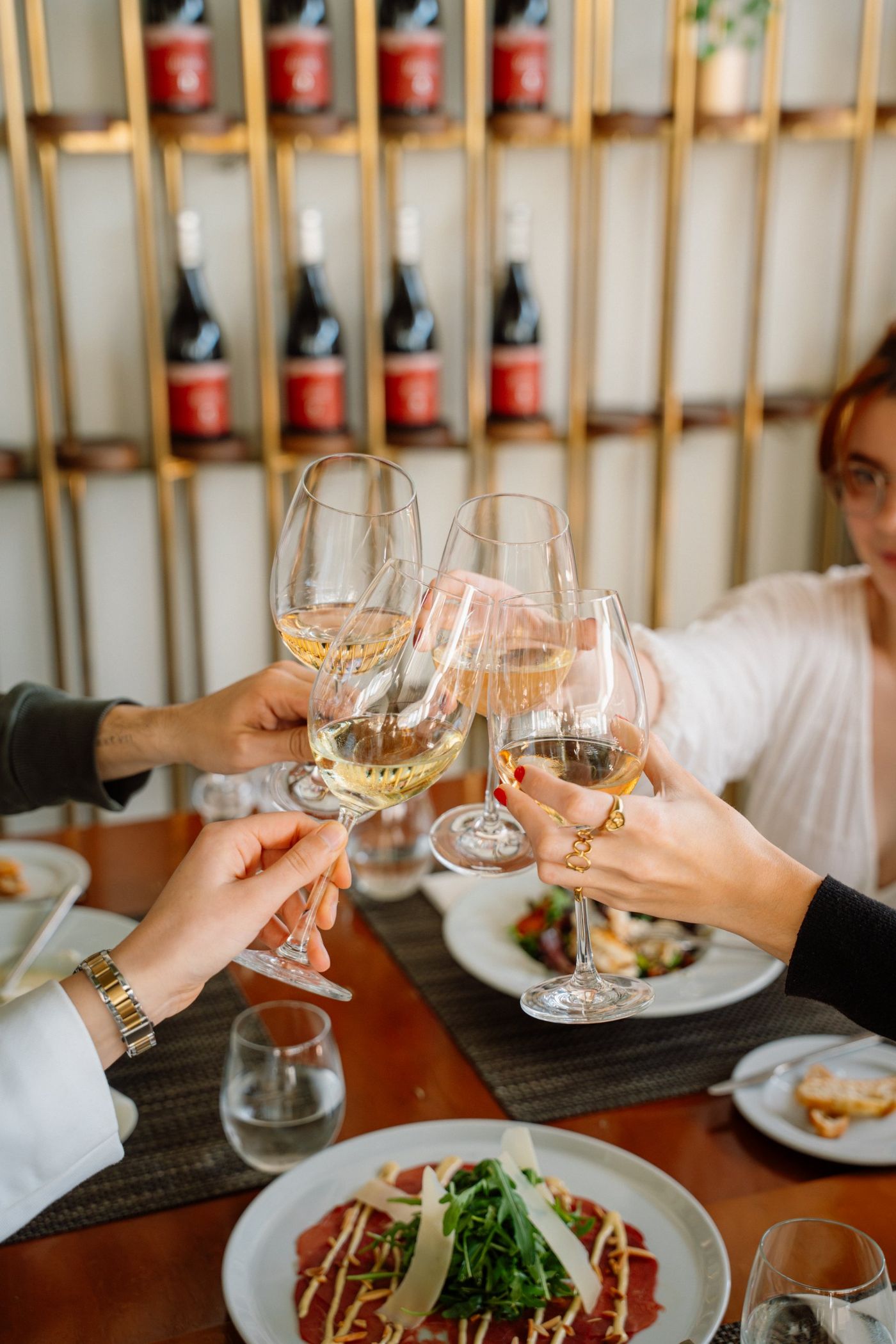 Guests raising their glasses at a table in Saudade